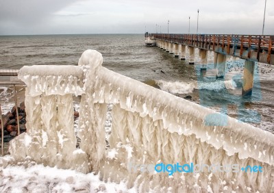 Ice Covered Staircase On The Beach Stock Photo