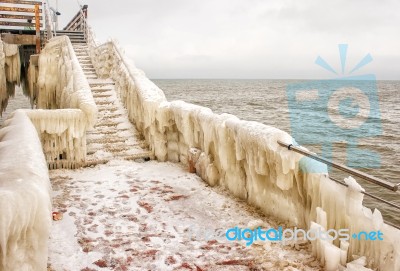 Ice Covered Staircase On The Beach Stock Photo