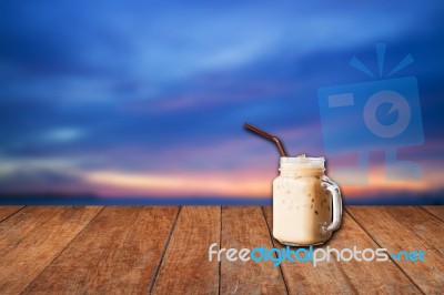 Iced Coffee Cup With Blue Sunset Sky Stock Photo