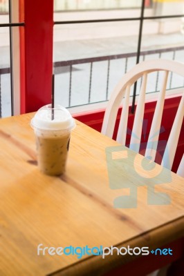 Iced Coffee Serving On Wooden Table Stock Photo