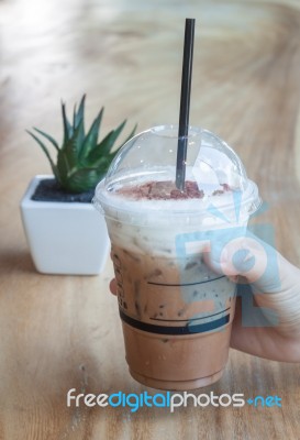 Iced Coffee With Green Plant Background Stock Photo