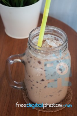 Iced Coffee With Green Plant Background Stock Photo