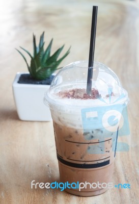 Iced Coffee With Green Plant Background Stock Photo