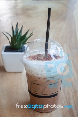 Iced Coffee With Green Plant Background Stock Photo