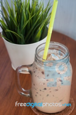 Iced Coffee With Green Plant Background Stock Photo