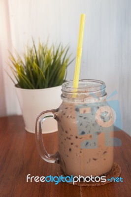 Iced Coffee With Green Plant Background Stock Photo