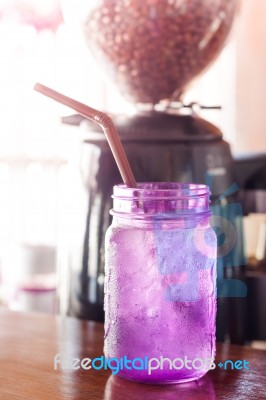 Iced Drink In Violet Glass In Coffee Shop Stock Photo