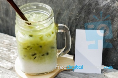 Iced Green Tea Latte With Blank Name Card Stock Photo