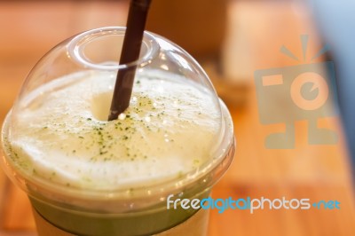 Iced Green Tea Latte With Milk Foam Stock Photo