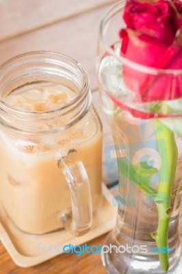 Iced Milk Coffee Serving On Wooden Table Stock Photo