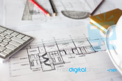 Image Of Blueprints With Level Pencil And Hard Hat On Table Stock Photo