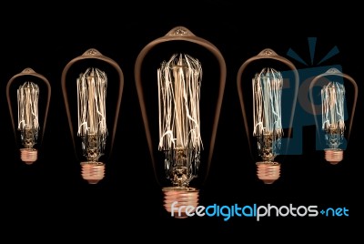 Incandescent Light Bulb On Black Background Stock Photo