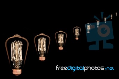 Incandescent Light Bulb On Black Background Stock Photo