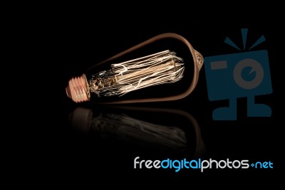 Incandescent Light Bulb On Black Background Stock Photo