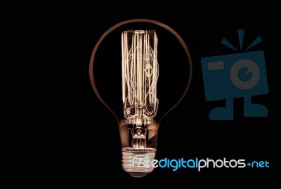 Incandescent Light Bulb On Black Background Stock Photo