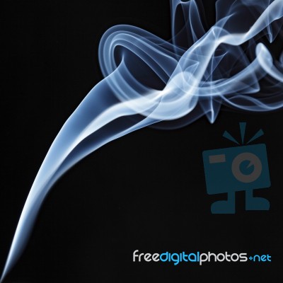 Incense Stick Smoke Trail Against A Black Background Stock Photo