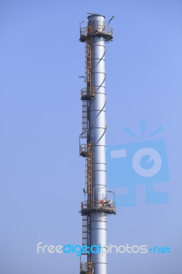 Industry Chimney Tube Against Clear Blue Sky Use For Industrial Stock Photo