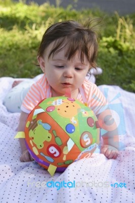 Infant Examining Ball Stock Photo