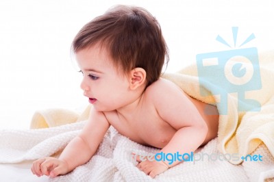 Infant Lying Under The Yellow Towel Stock Photo