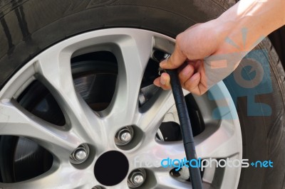 Inflating The Automobile Wheels Via A Pump Stock Photo