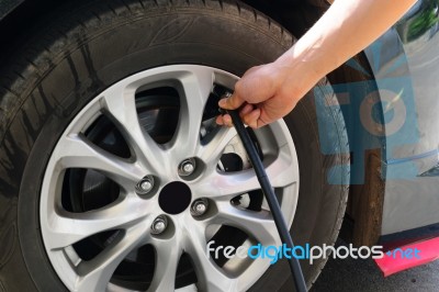 Inflating The Automobile Wheels Via A Pump Stock Photo