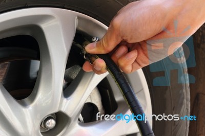 Inflating The Automobile Wheels Via A Pump Stock Photo