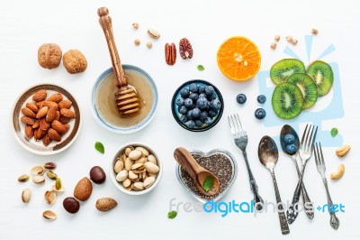 Ingredients For A Healthy Foods Background, Nuts, Honey, Berries… Stock Photo