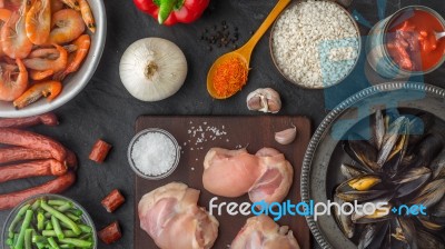 Ingredients For Paella On The Dark Stone Table Top View Stock Photo