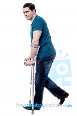 Injured Man With Crutches Stock Photo