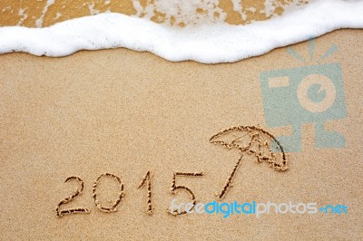 Inscription Of The Year 2015 Written In The Wet Yellow Beach Sand Stock Photo