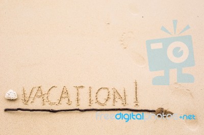 Inscription Of Vacation Written On Wet Yellow Beach Sand With Fo… Stock Photo