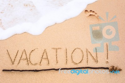 Inscription Of Vacation Written On Wet Yellow Beach Sand With Fo… Stock Photo