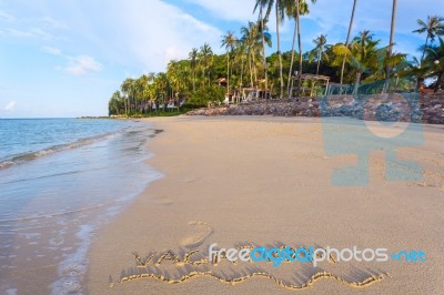 Inscription Of Vacation Written On Wet Yellow Beach Sand With Fo… Stock Photo