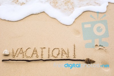 Inscription Of Vacation Written On Wet Yellow Beach Sand With Fo… Stock Photo