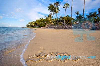 Inscription Of Vacation Written On Wet Yellow Beach Sand With Fo… Stock Photo