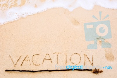 Inscription Of Vacation Written On Wet Yellow Beach Sand With Fo… Stock Photo