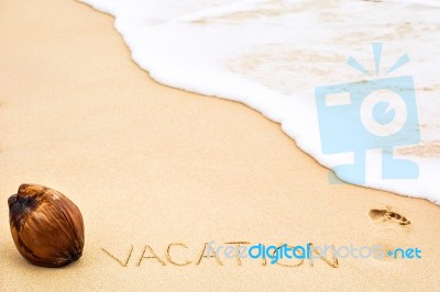 Inscription Of Word Vacation Written On Wet Yellow Beach Sand, F… Stock Photo