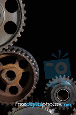 Interlocking Industrial  Cogwheels Top View On Black Background Stock Photo