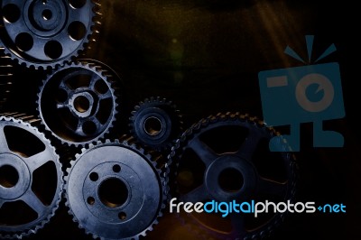 Interlocking Industrial  Cogwheels Top View On Black Background Stock Photo