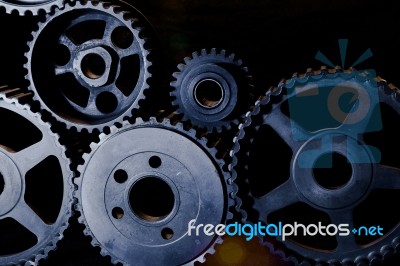 Interlocking Industrial  Cogwheels Top View On Black Background Stock Photo