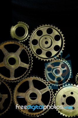 Interlocking Industrial  Cogwheels Top View On Black Background Stock Photo