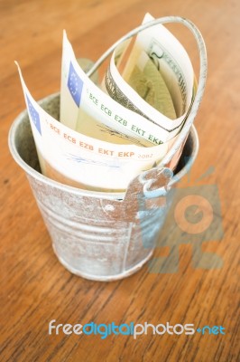 International Currencies Bank Note In The Bucket Stock Photo