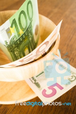 International Currencies Bank Note On Wooden Table Stock Photo