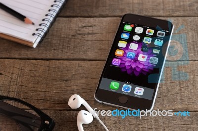 Iphone 6 And Ios Application On Wood Desk Stock Photo