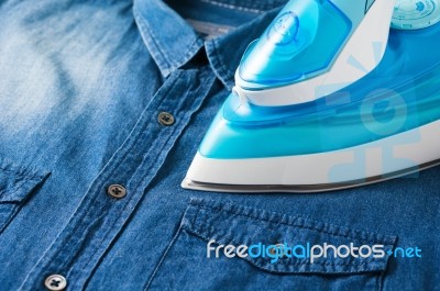 Ironing Blue Jean Shirt Stock Photo