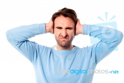 Irritated Man Blocking His Ears Stock Photo