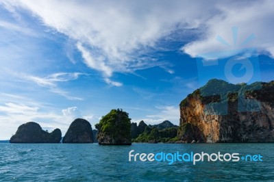 Island Cliffs In Turquois Sea And Blue Sky Stock Photo