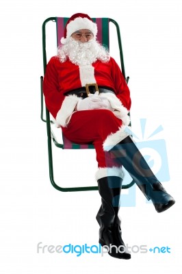 Isolated Aged Santa Relaxing. Vacation Time Stock Photo