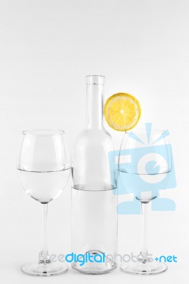 Isolated Bottle And Glasses With Lemon Stock Photo