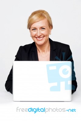 Isolated Smiling Corporate Lady Working On Laptop Stock Photo